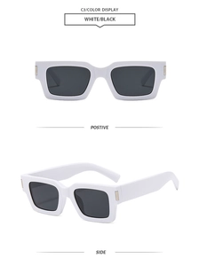 Detail view of white thick square frame sunglasses with gold temple accents and dark lenses