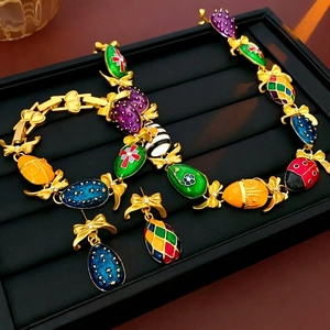 Vintage gold-plated floral butterfly jewelry set with colorful enamel pendants