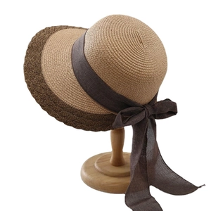 Women's two-tone straw sun hat with brown ribbon bow for beach vacation and sun protection