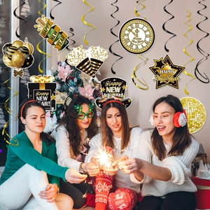 Golden and black New Year foil swirls and paper cutouts hanging for festive party decor
