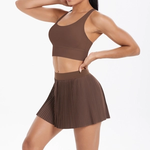 Two-piece dark brown sports set featuring a U-neck bra and high-waisted pleated athletic skirt