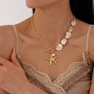 Detail of starfish pendant and shell bead necklace with OT toggle clasp on collarbone