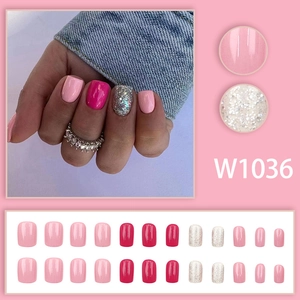 Short square press-on nails in pink and fuchsia with glitter finish set on display