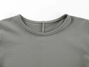 Detailed close-up of grey knit T-shirt crew neck with high-quality double stitching
