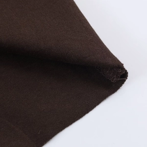 Macro detail of dark brown knitted fabric texture and high-quality hem stitching