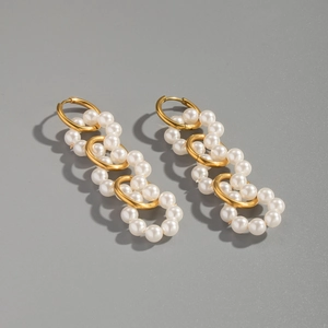 Close-up of elegant 18K gold stainless steel hoop earrings with white pearl chain drop