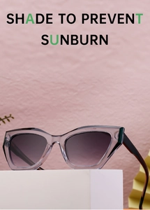 Cat-eye sunglasses with grey resin frame and gradient lenses on a geometric display