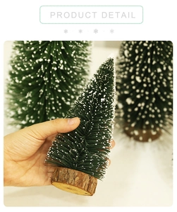 Close-up of mini flocked Christmas tree with snow effect and natural wooden base