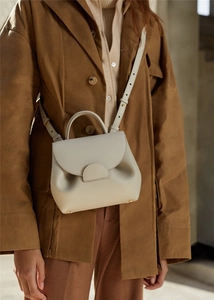 Beige genuine leather trapezoid handbag with top handle and crossbody strap detail
