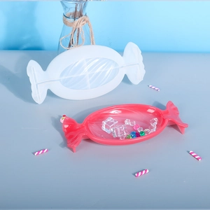 Detail showing candy shaped silicone mold with a pink resin tray and decorative crystals