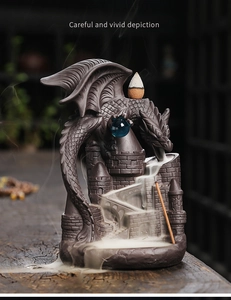 Detail of dragon dragon backflow incense burner showing smoke flowing down castle stairs
