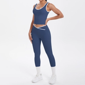 Front view of two-piece navy yoga set with white contrast trim on sports bra and leggings