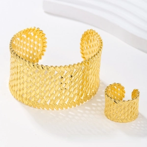 Detailed macro view of the gold-plated hollow-out leaf cuff bracelet and matching ring set