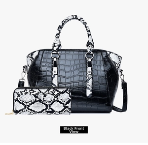 Detail of black faux crocodile leather handbag and snake print wallet set for women