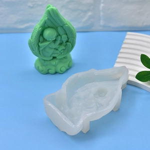 DIY silicone mold for baby angel candle, showing translucent mold and green 3D figure