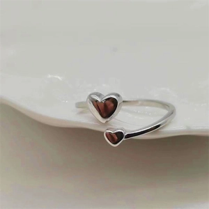 Detail shot of a polished S925 sterling silver open ring with double heart design