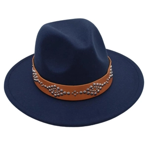 Detail of navy blue wool fedora hat featuring a brown leather band with silver metal studs