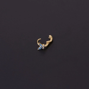 Minimalist gold butterfly cartilage hoop earring with blue zircon wings on dark background