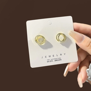 Detail of S925 silver needle hoop earrings with pavé zircons and translucent bead