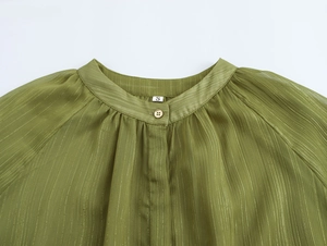 Detail of olive green chiffon blouse collar with gold stripes, pleats and gold button