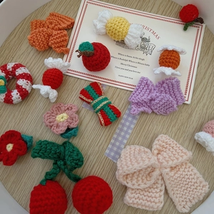 Detailed macro shot of handmade crochet Christmas ornaments on a white plate