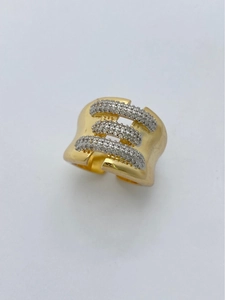 Detailed macro view of gold plated wide ring featuring three rows of pavé set zircons
