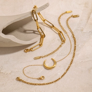 18K gold plated stainless steel bracelet set with crescent pendant on stone base