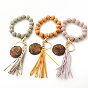 Detail view of leopard print beads, long leather tassels, and Mama engraved wooden tags