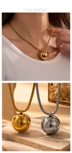 Macro view of gold and silver mirror-polished sphere pendants on snake bone chains