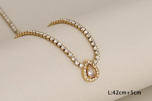 Close-up of gold-plated tennis necklace with pear-shaped zircon pendant and 42cm length