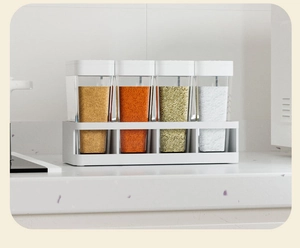 Detailed view of 4-piece spice jar set with white lids on a clean kitchen countertop