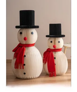 Detail of handcrafted paper origami snowmen with mini scarves for tabletop Christmas decor