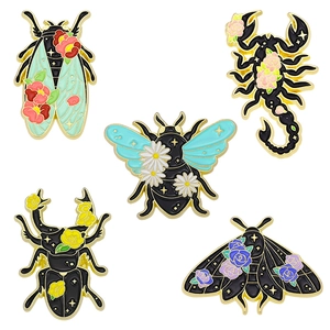 Five creative insect enamel pins including moth and scorpion with floral gold patterns