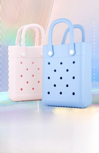 Pink and blue EVA tote bags with holes on a shimmering holographic background