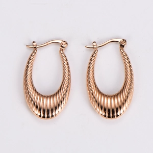 Detail shot of rose gold U-shaped earrings with elegant vertical striped texture