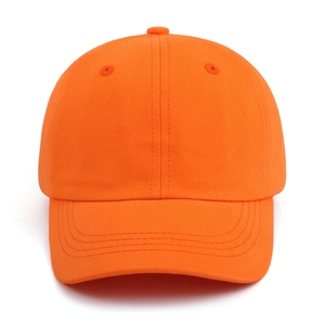 Close-up of vibrant orange cotton baseball cap showing twill texture and stitching