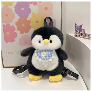 Close-up of cute penguin plush backpack with blue plaid bib and adjustable black straps