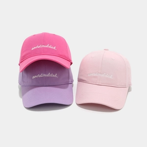 Three cotton baseball caps in rose, purple, and pink with overstimulated embroidery