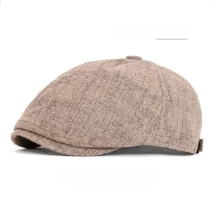 Detail view of khaki cotton blend newsboy cap showing six-panel stitching and top button