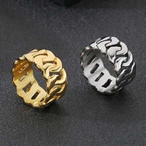 Detailed comparison of gold and silver stainless steel Cuban link rings on dark background