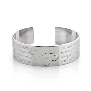 Detailed view of silver titanium steel open bangle with engraved text and Om symbol