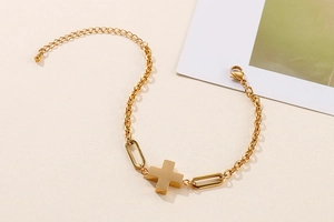 Detailed view of golden stainless steel cross pendant with lobster clasp and adjustable chain