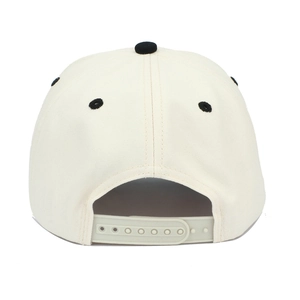 Two-tone embroidered trucker hat in cream and black with adjustable snapback closure