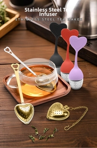 Detailed close-up of heart-shaped stainless steel tea infusers with handle and chain