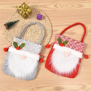 Close-up of gnome Christmas gift bags with plush faux fur and knitted fabric textures