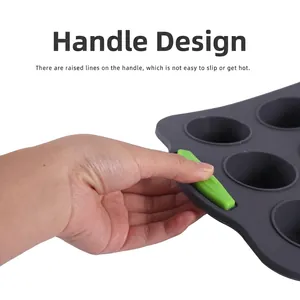 Grey 12-cup silicone muffin pan with green heat-resistant anti-slip handles
