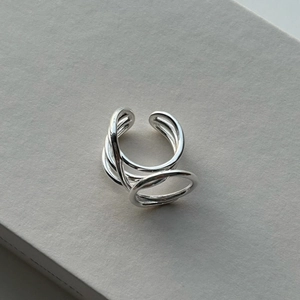 Close-up of minimalist S925 sterling silver multi-layer interlocking ring on grey background