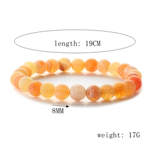 Detail of 8mm orange weathered agate beaded bracelet showing natural stone texture and 19cm length
