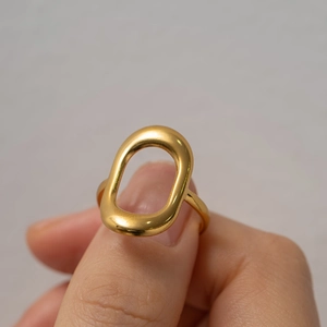 Close-up of hand holding a minimalist 18k gold-plated hollow geometric rectangle ring