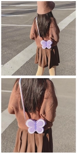 Détail d'un sac papillon en silicone violet pour fille porté en extérieur au soleil